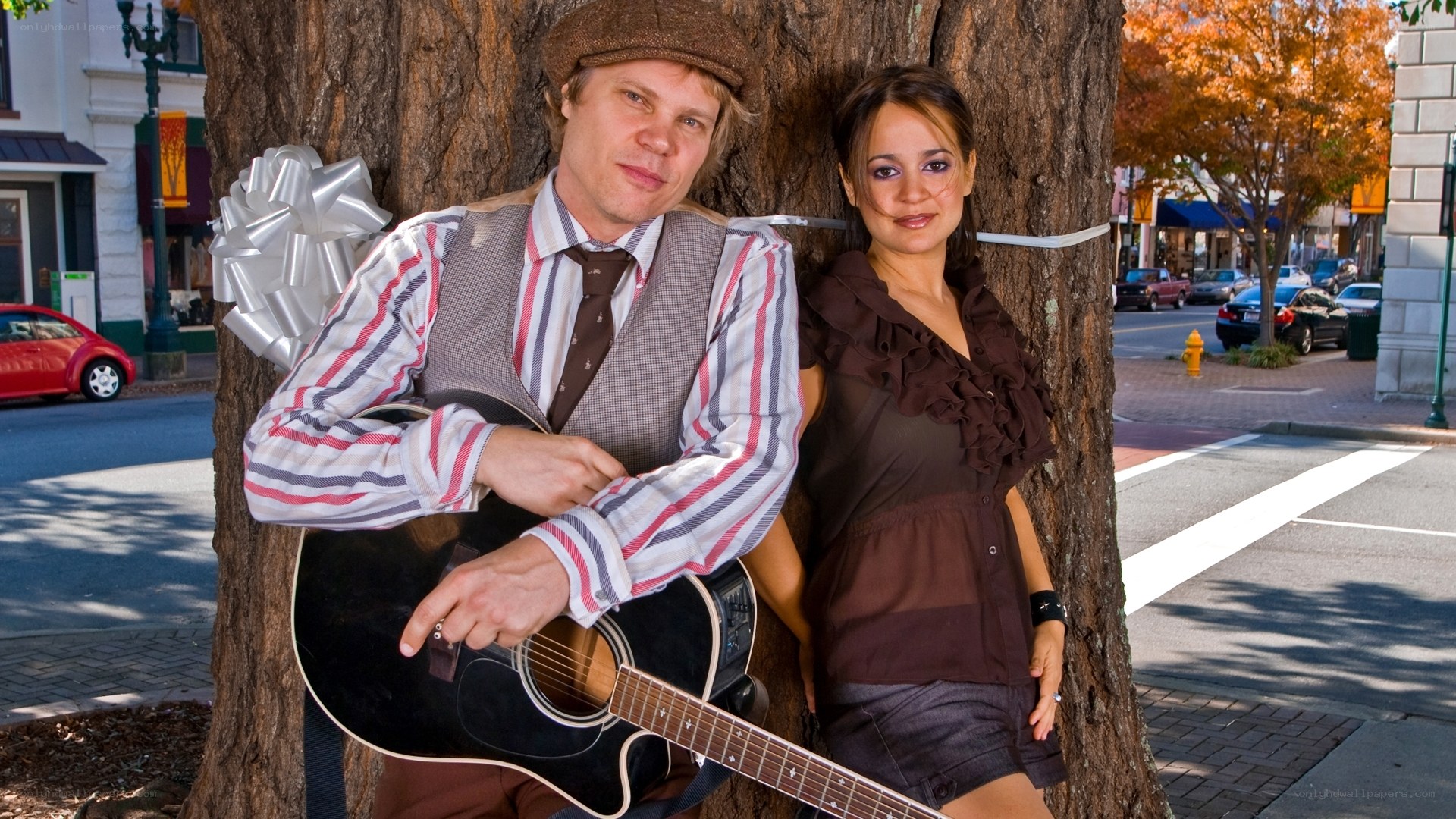Musicians posing by a tree