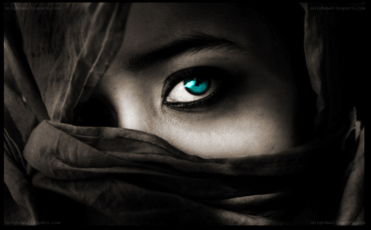 mysterious eye with glowing blue iris