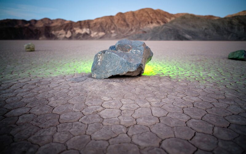 Mysterious rocks on cracked desert floor
