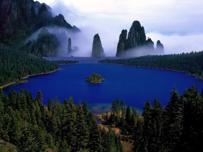 Mystical lake with forest and mountains