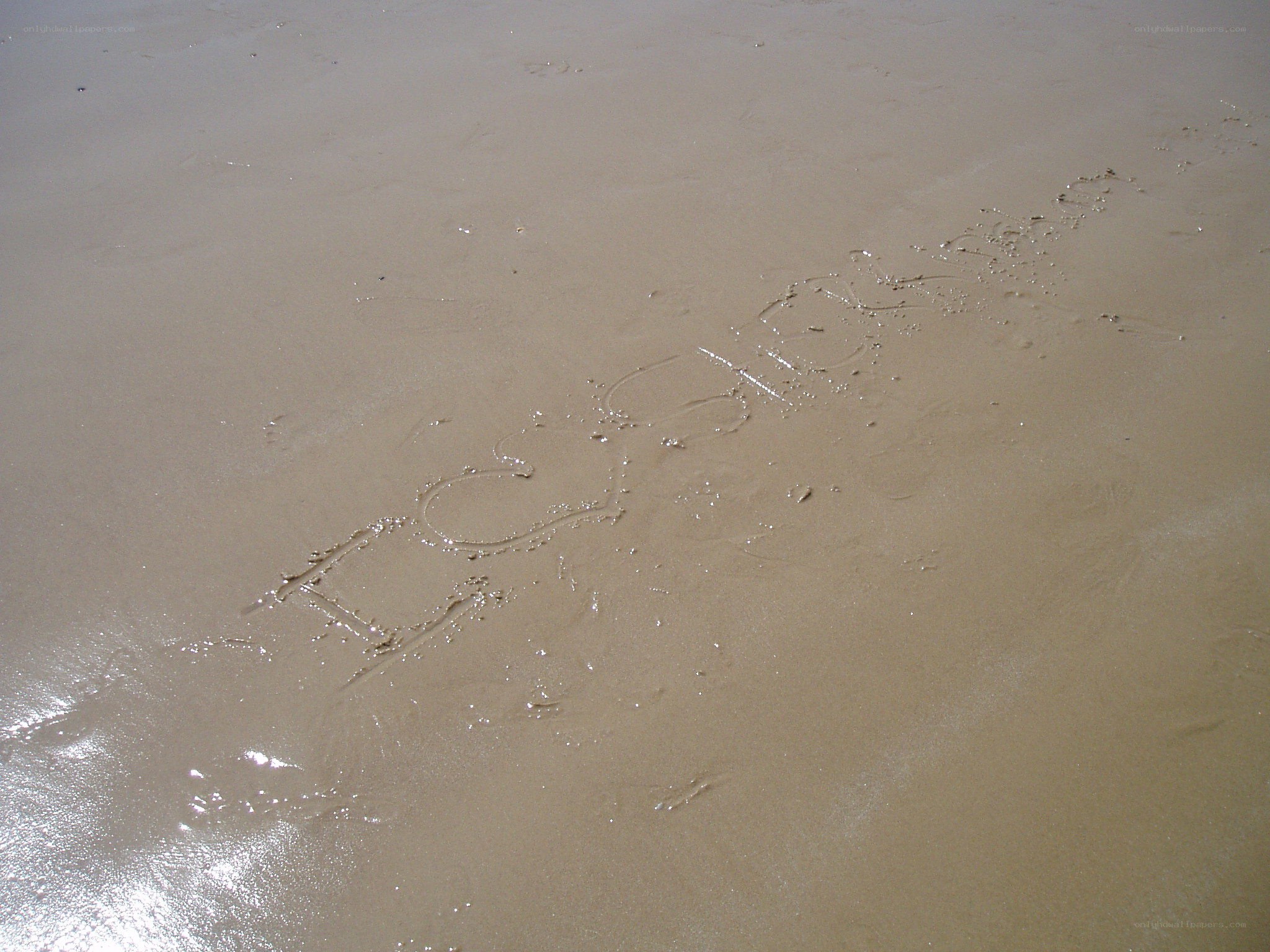 name written in wet sand