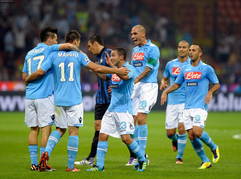 Napoli players celebrate on field