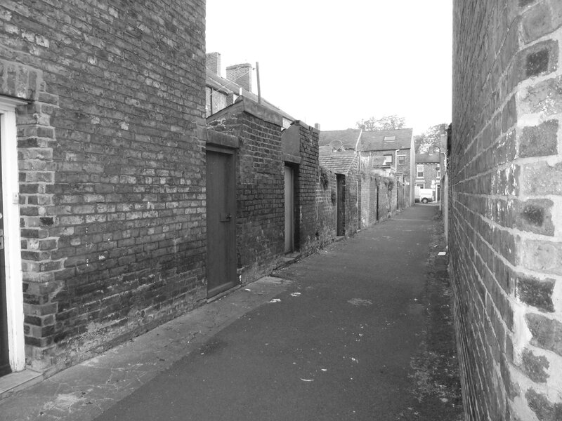 narrow alley between brick buildings