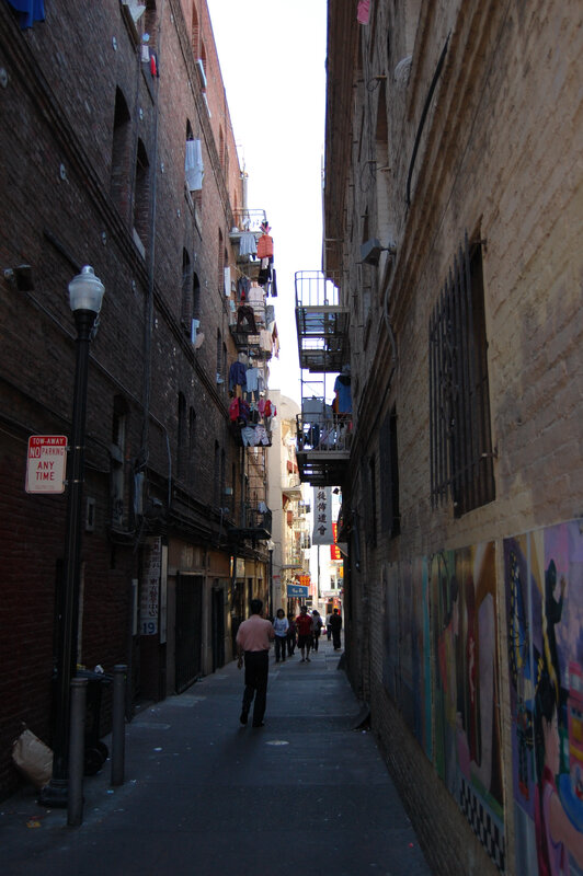 Narrow alley with laundry and murals
