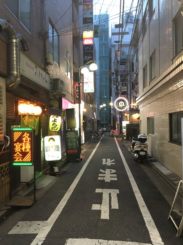 Narrow Alley with Neon Signs
