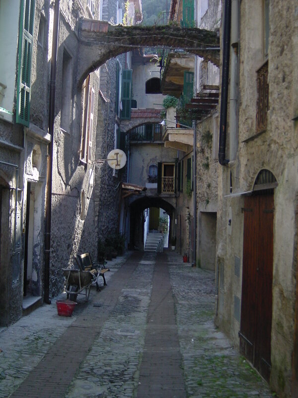 narrow alley with stone arches