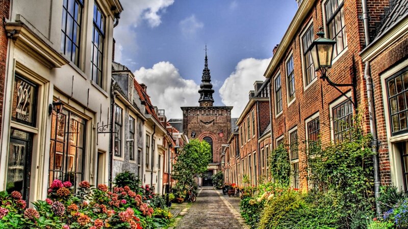 Narrow street with church tower