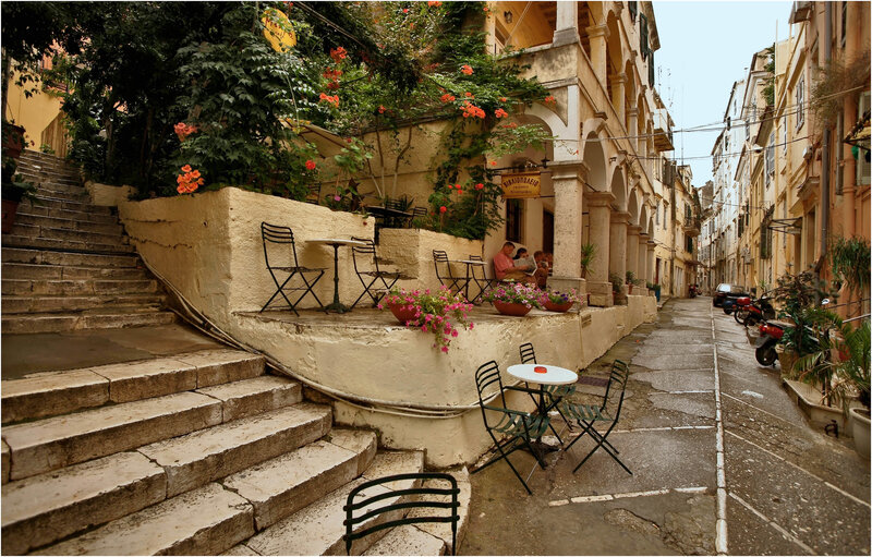 Narrow street with outdoor cafe in Greece