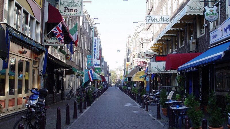 Narrow street with shops and awnings