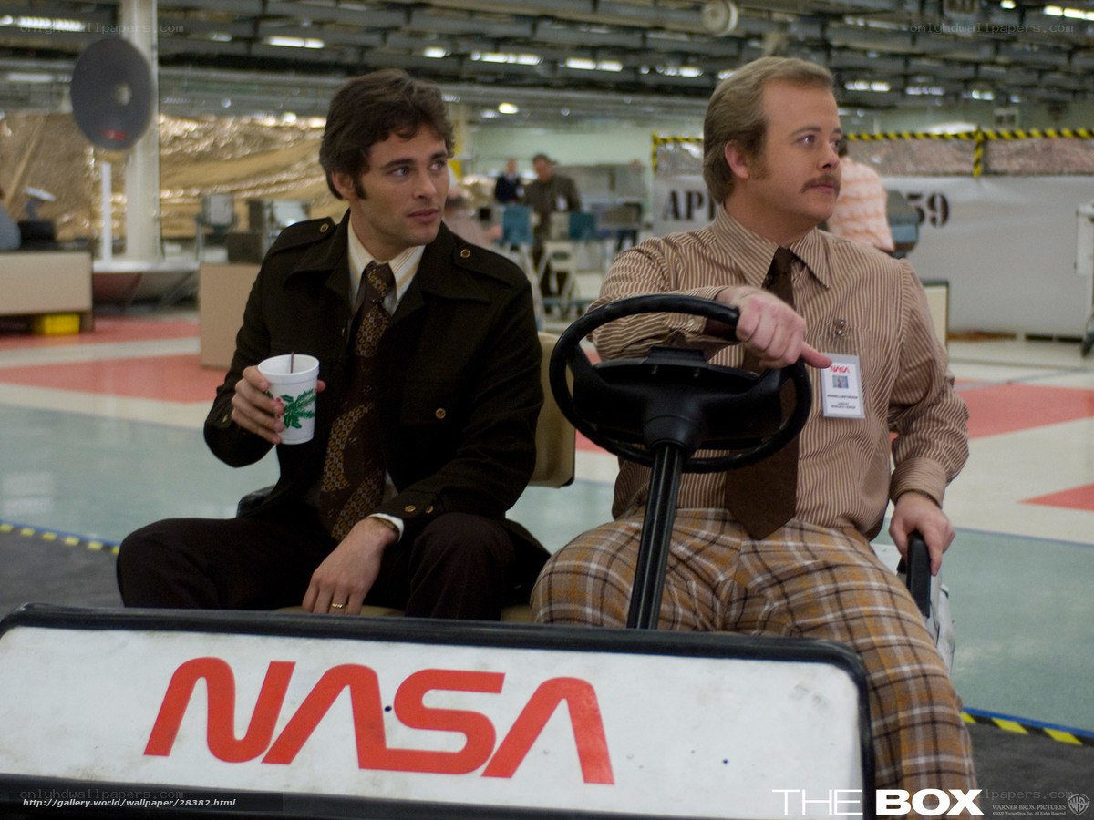 NASA workers in a golf cart