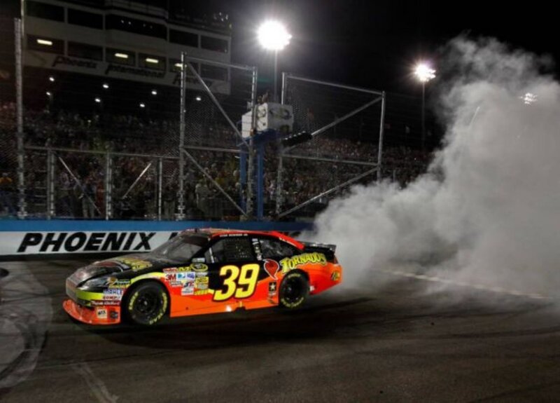 NASCAR car doing burnout at night