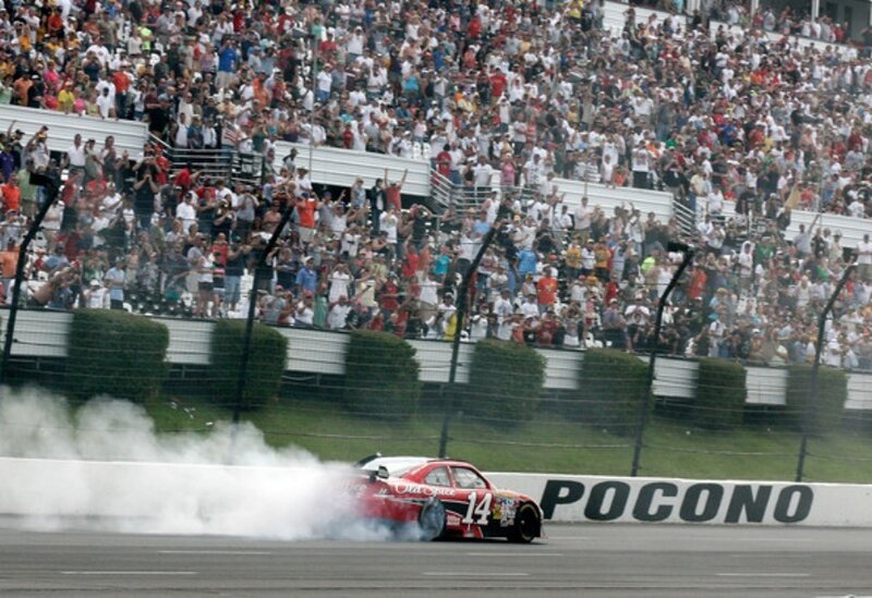 NASCAR driver celebrating on track