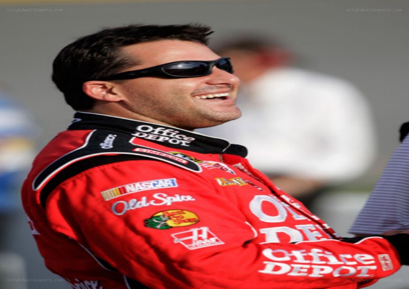 NASCAR driver smiling in uniform