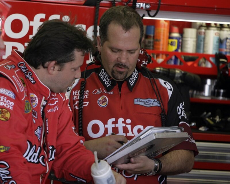 NASCAR team members reviewing notes