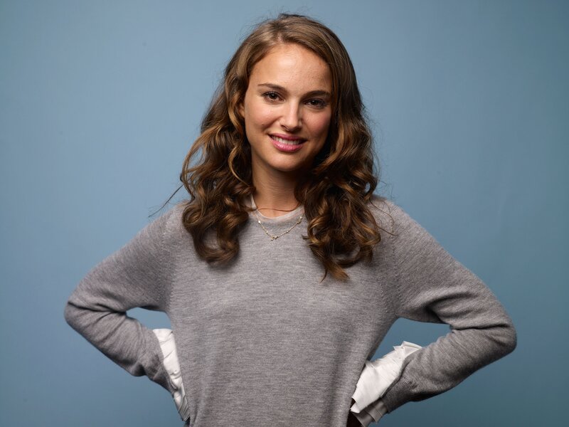 Natalie Portman smiling in gray sweater