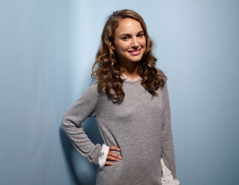 Natalie Portman smiling in gray sweater