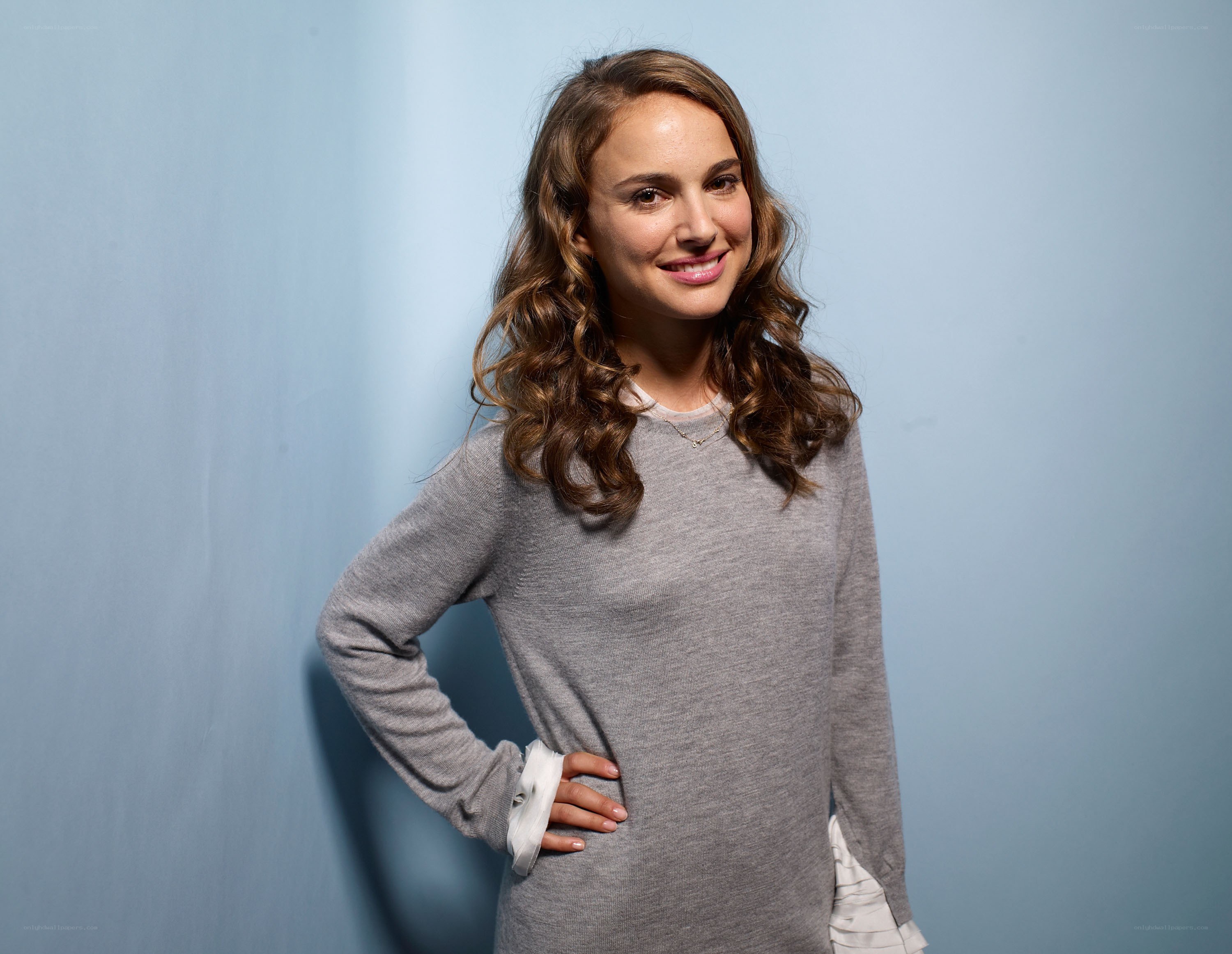Natalie Portman smiling in gray sweater