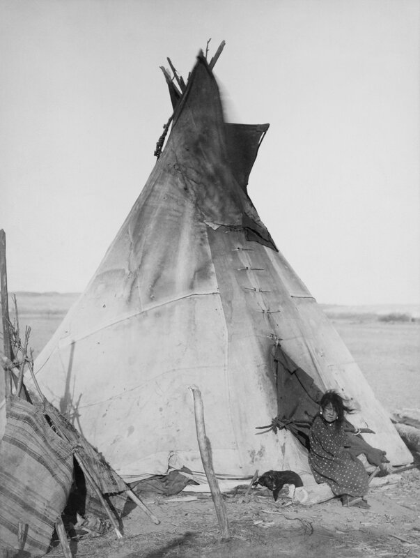 Native American child by tipi