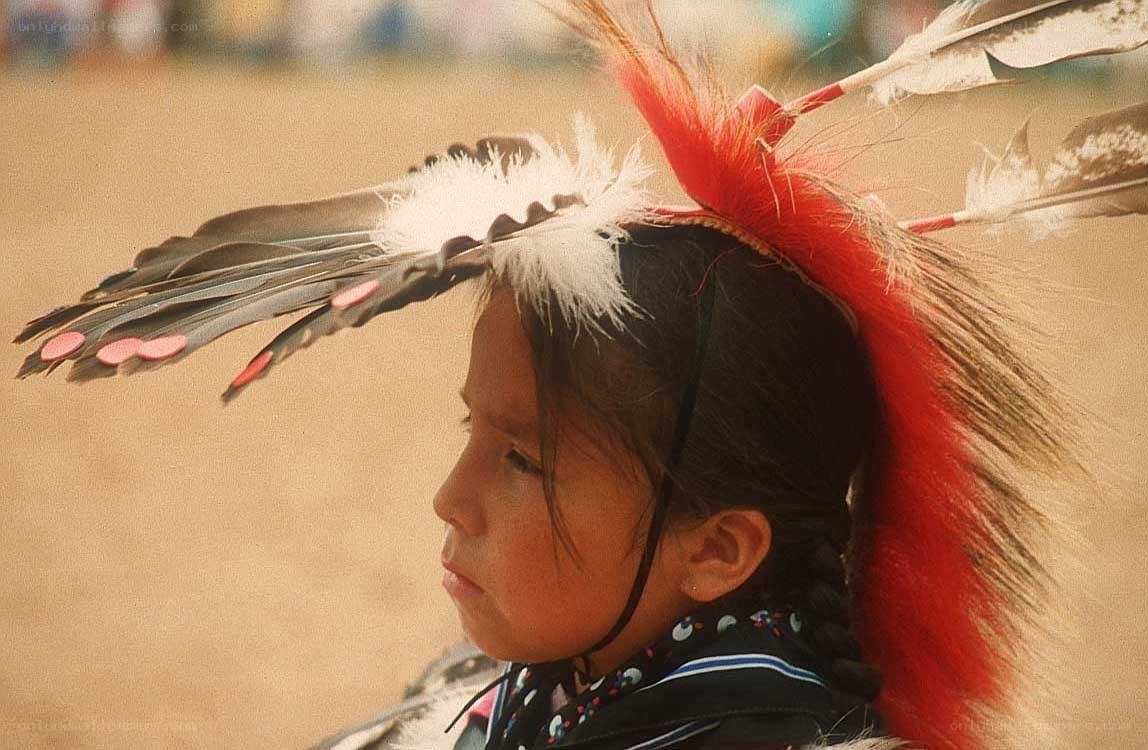 Native American child in feather headdress