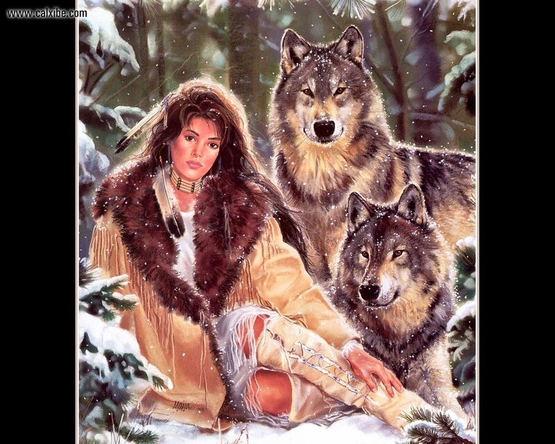 Native woman with wolves in snow