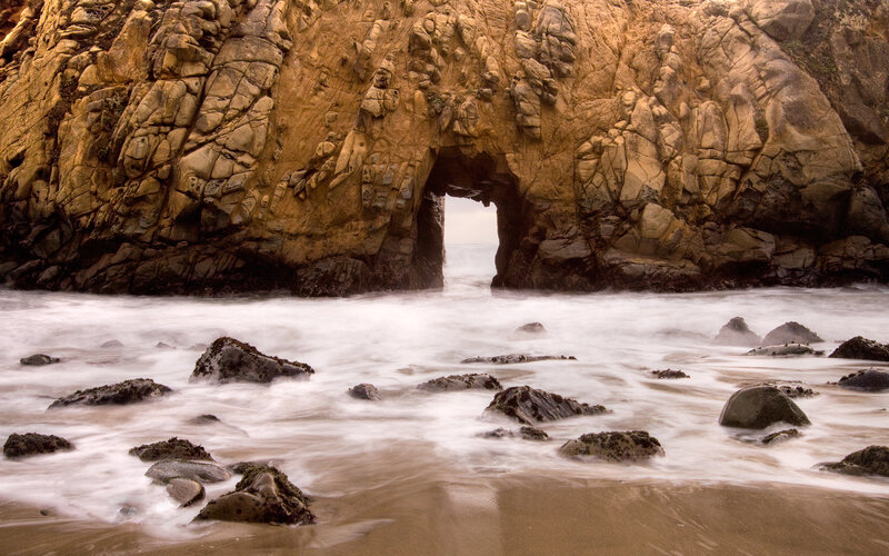 Natural rock arch at coastal beach
