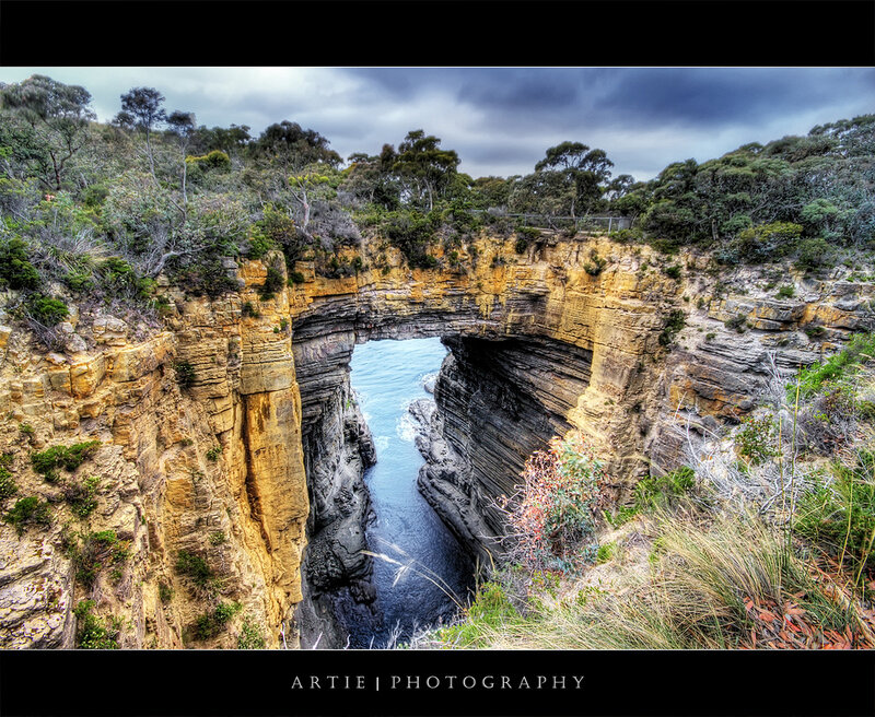 Natural rock arch at coastal cliff