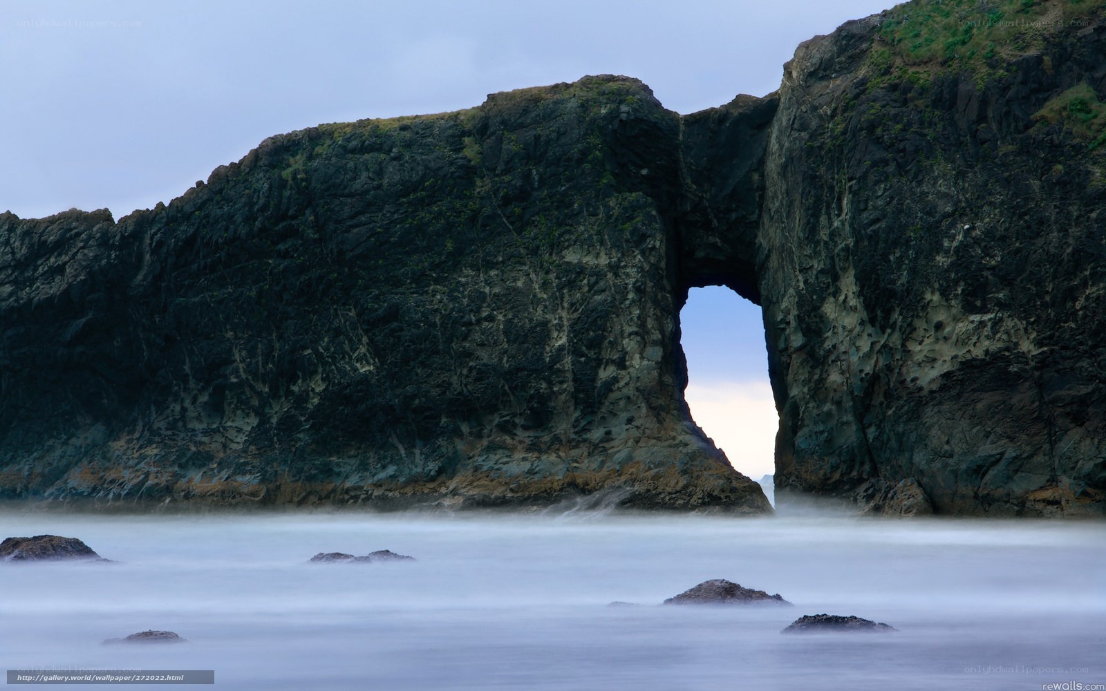 Natural rock arch at coastal cliff
