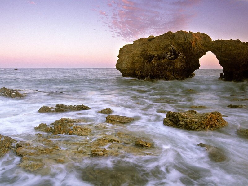 Natural rock arch at sunset