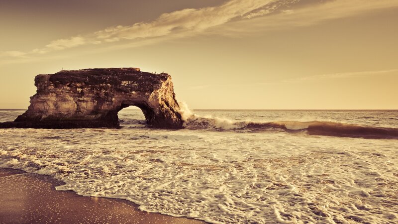 Natural rock arch at sunset