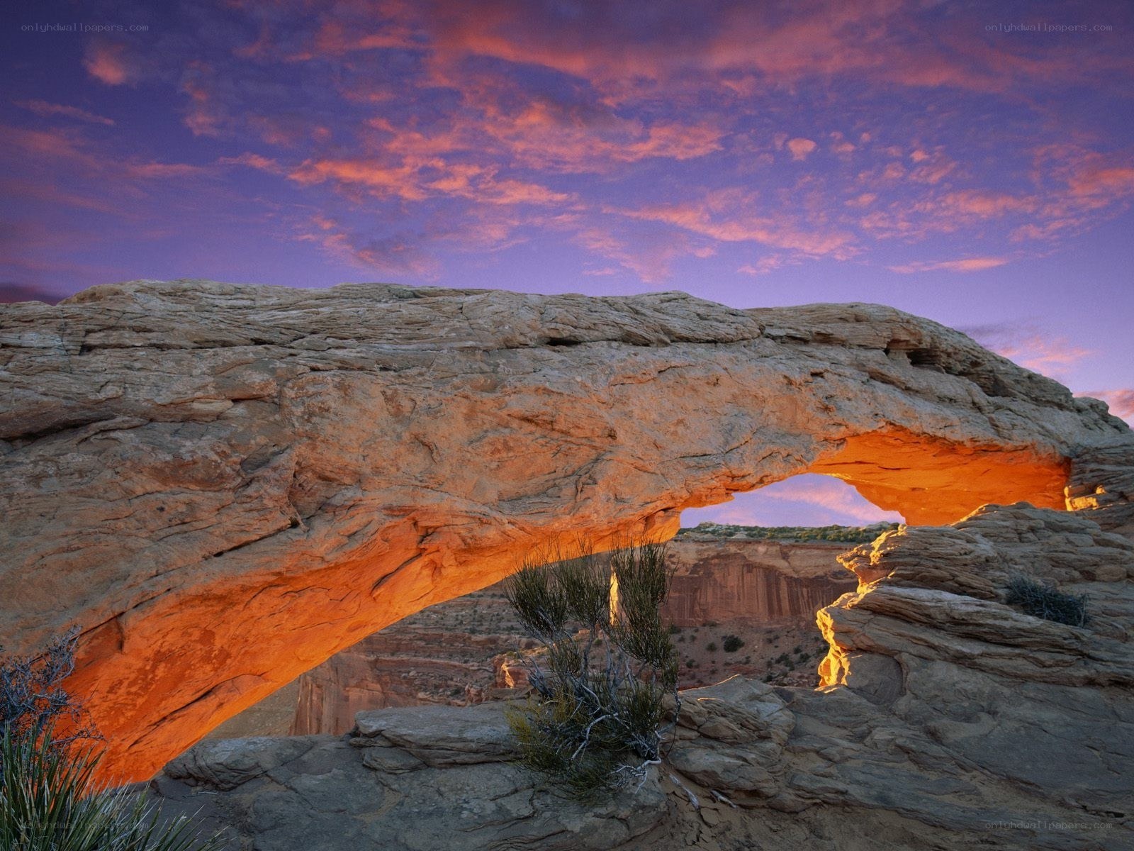 Natural rock arch at sunset