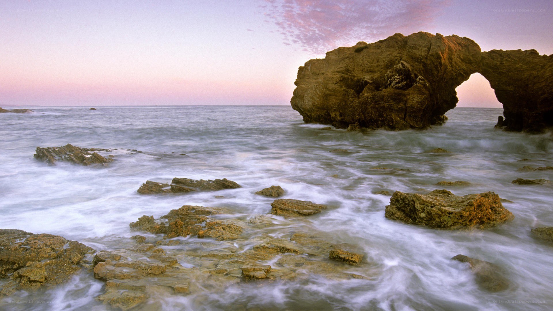 Natural rock arch at sunset
