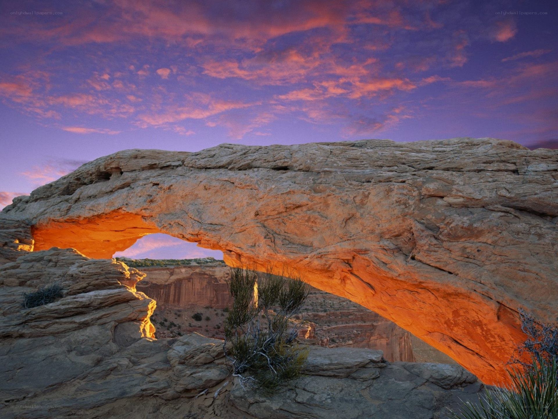 Natural rock arch at sunset
