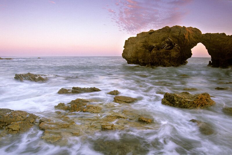 Natural rock arch at sunset