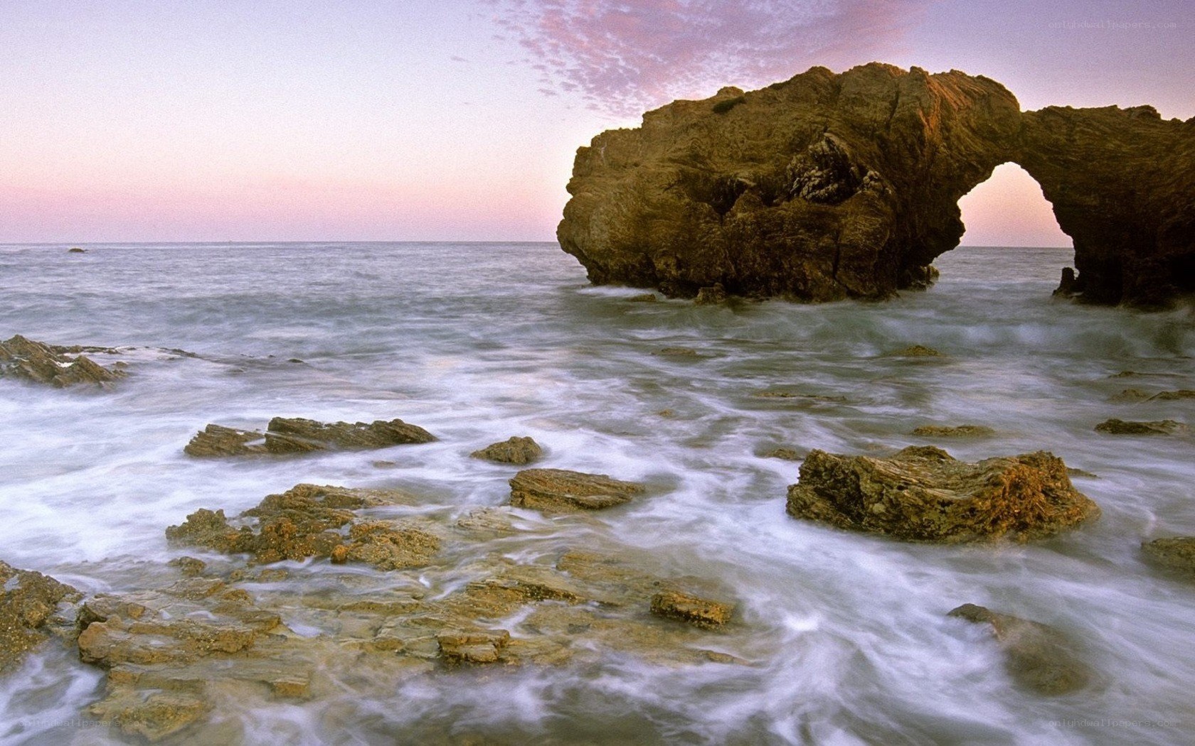Natural rock arch at sunset