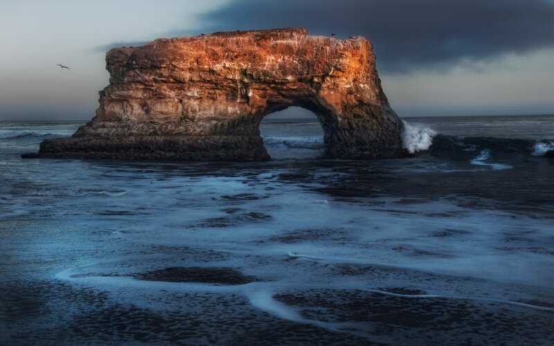 Natural rock arch at sunset