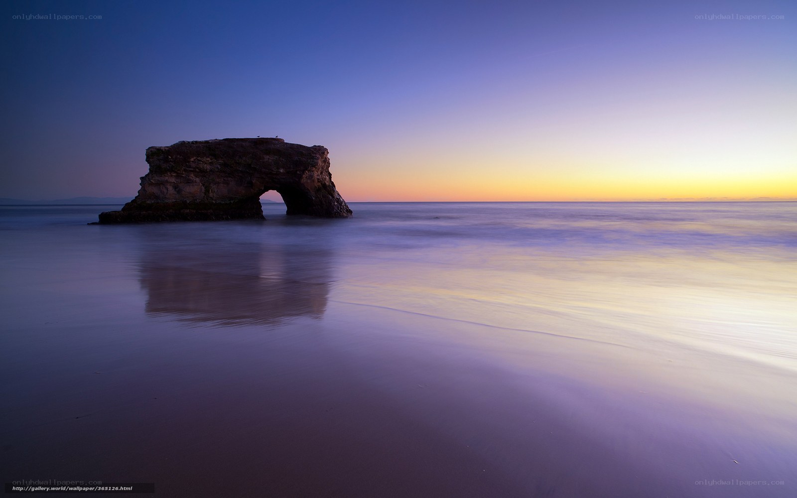 Natural rock arch at sunset