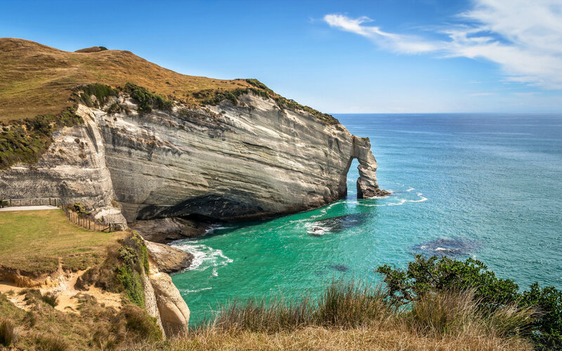 Natural Rock Arch Formation — Blue, Serene, Afternoon, Photograph, Ocean, Cliff