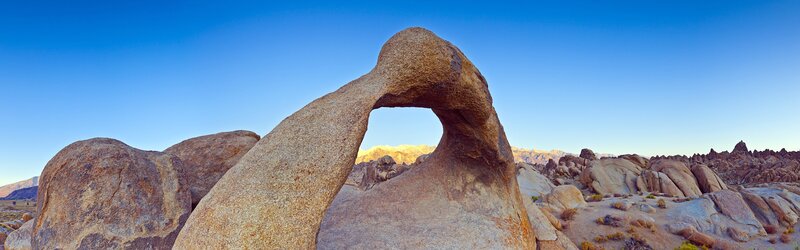 Natural rock arch in desert landscape