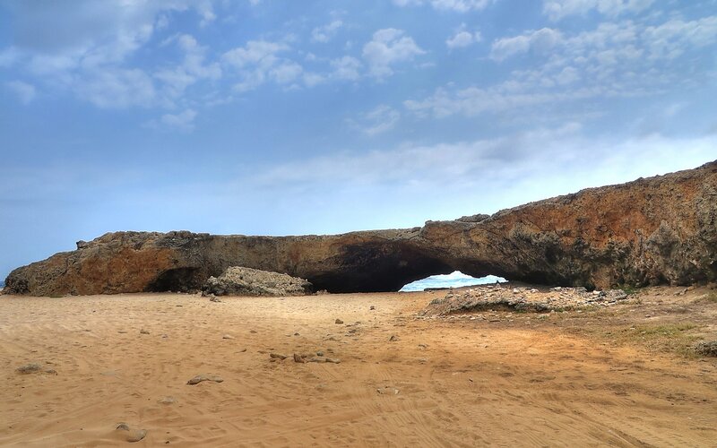 Natural Rock Arch on Beach — Blue