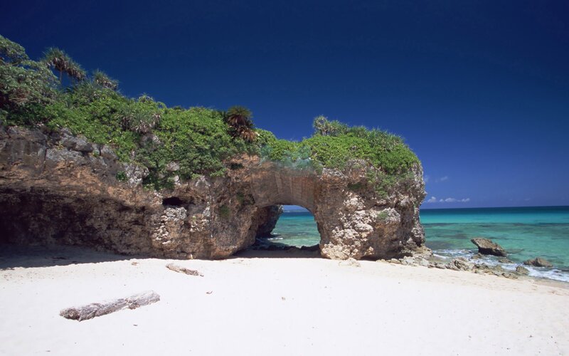 Natural rock arch on tropical beach
