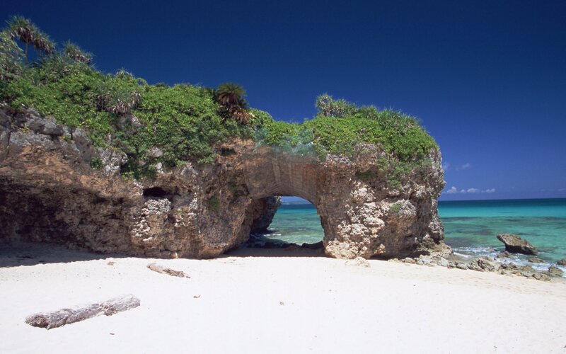 Natural rock arch on tropical beach