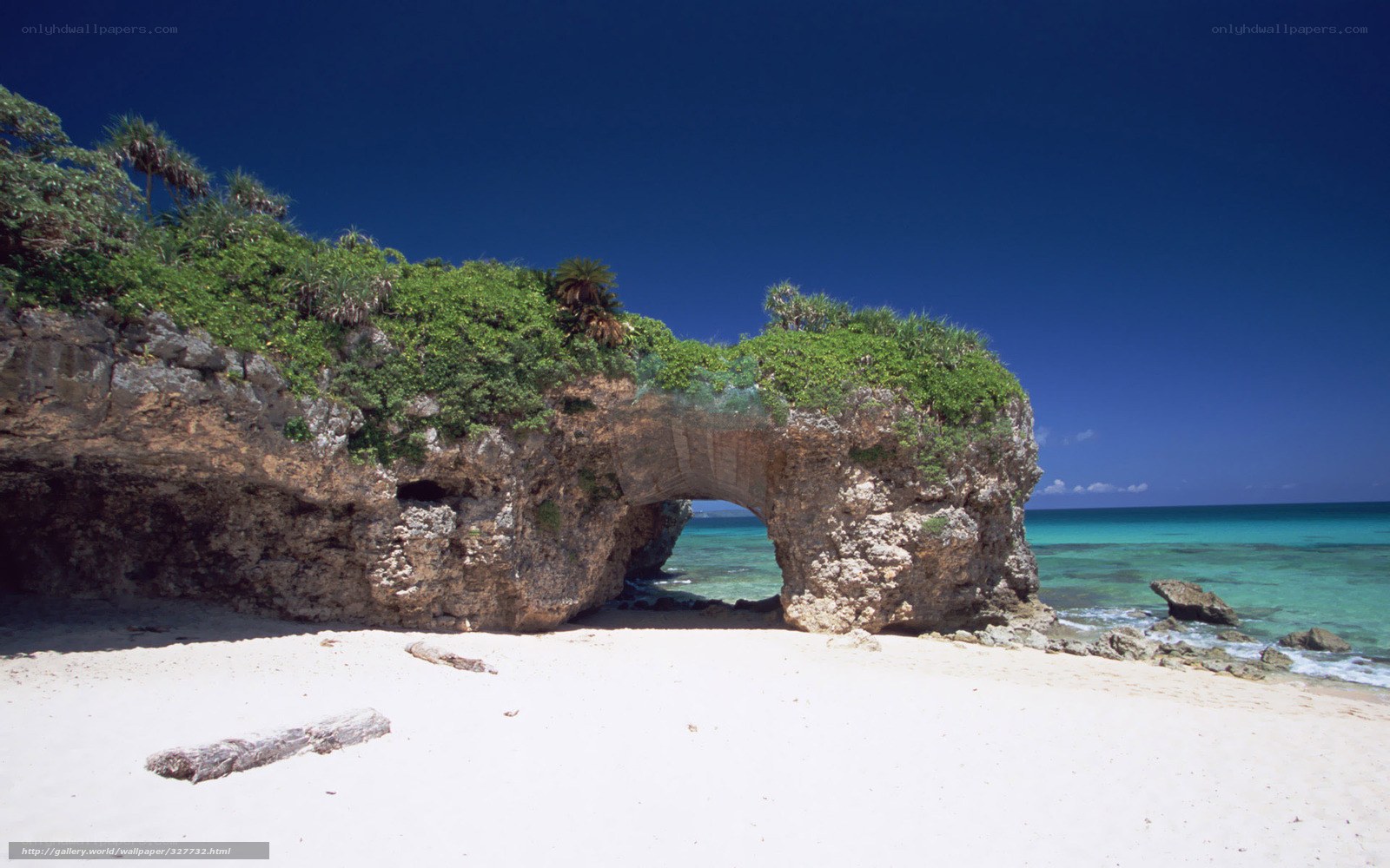 Natural rock arch on tropical beach