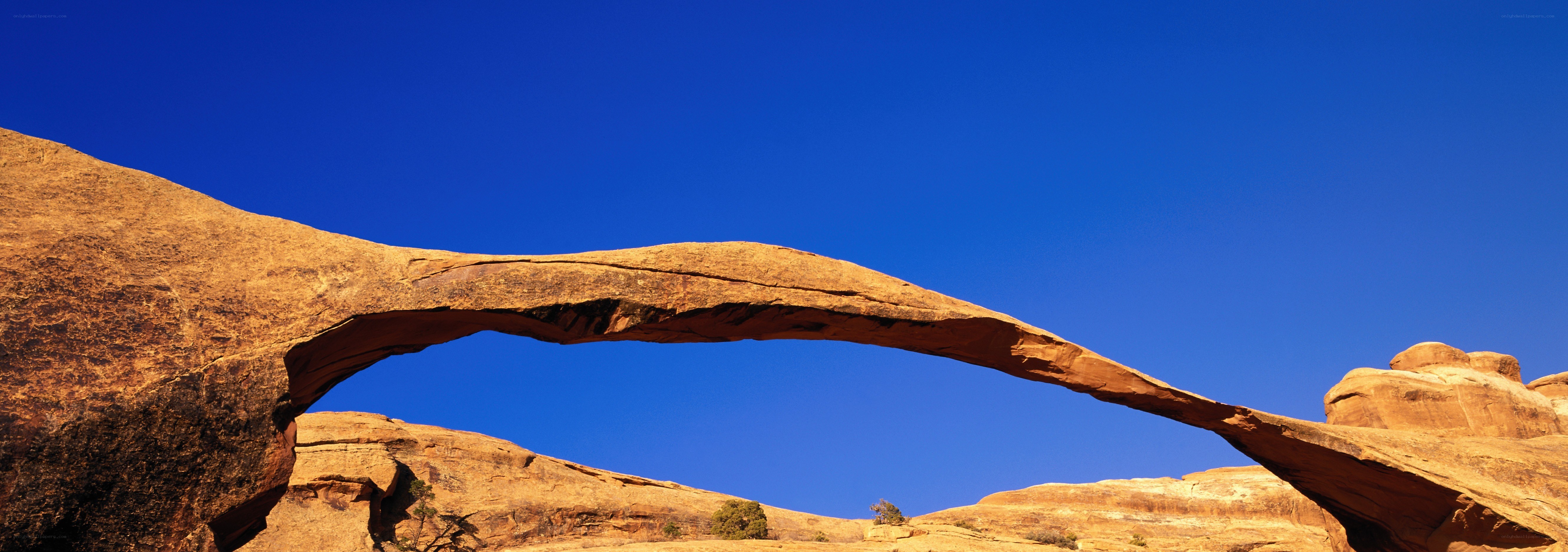 Natural rock arch under blue sky