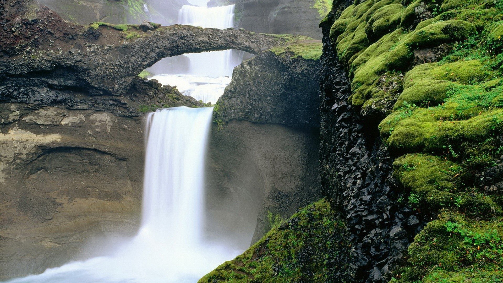 Natural rock arch waterfall