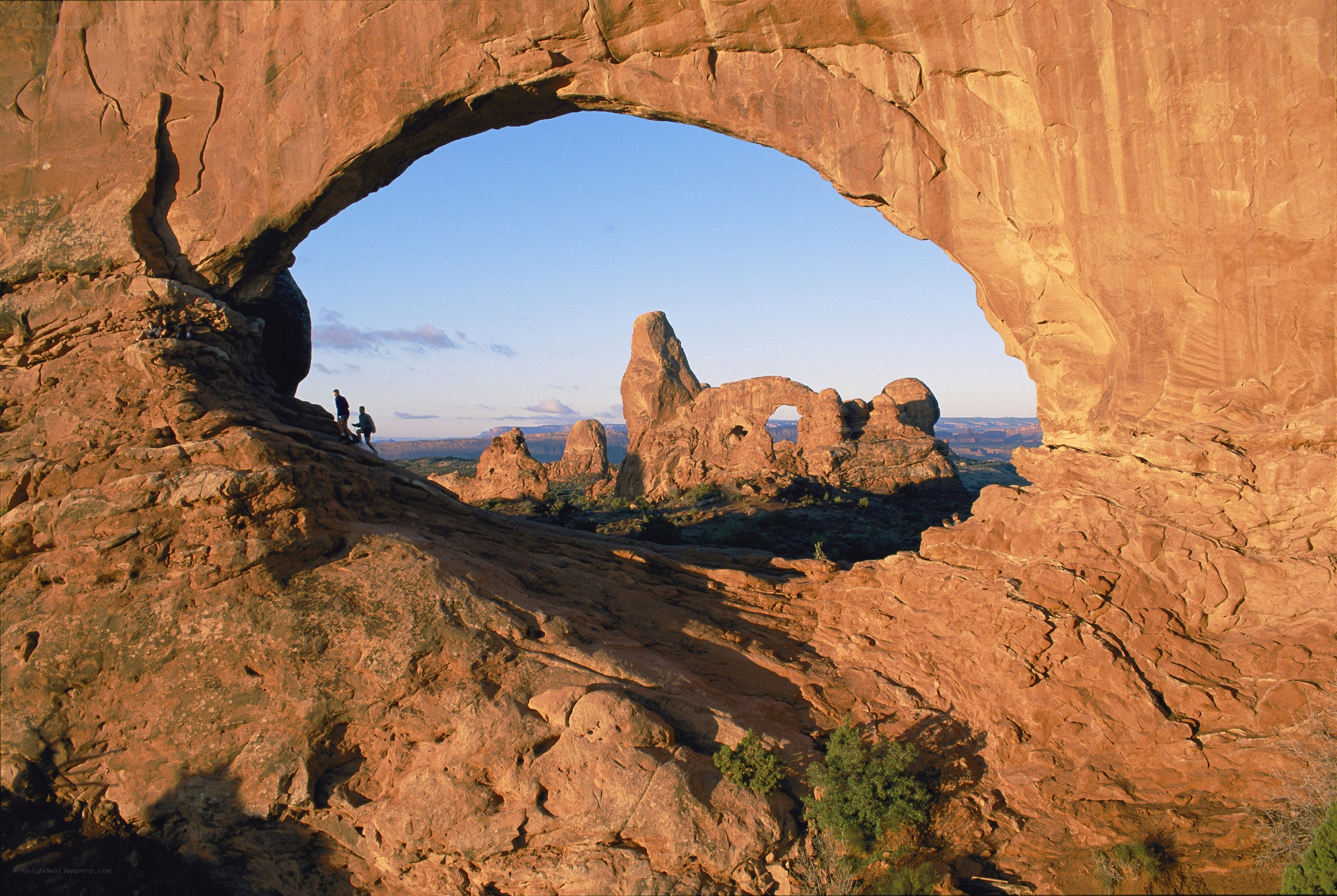 Natural rock arch with hikers