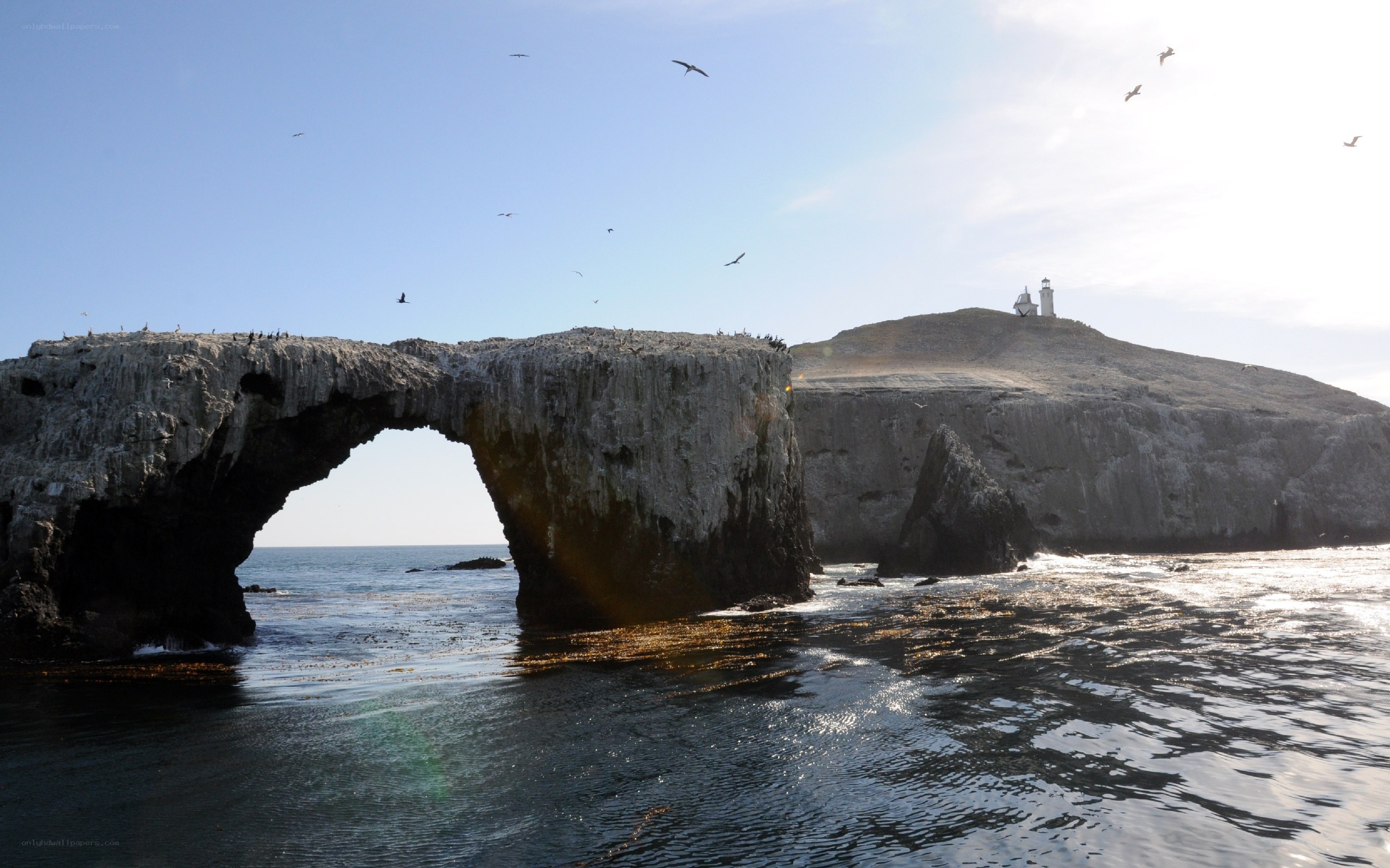 Natural rock arch with lighthouse