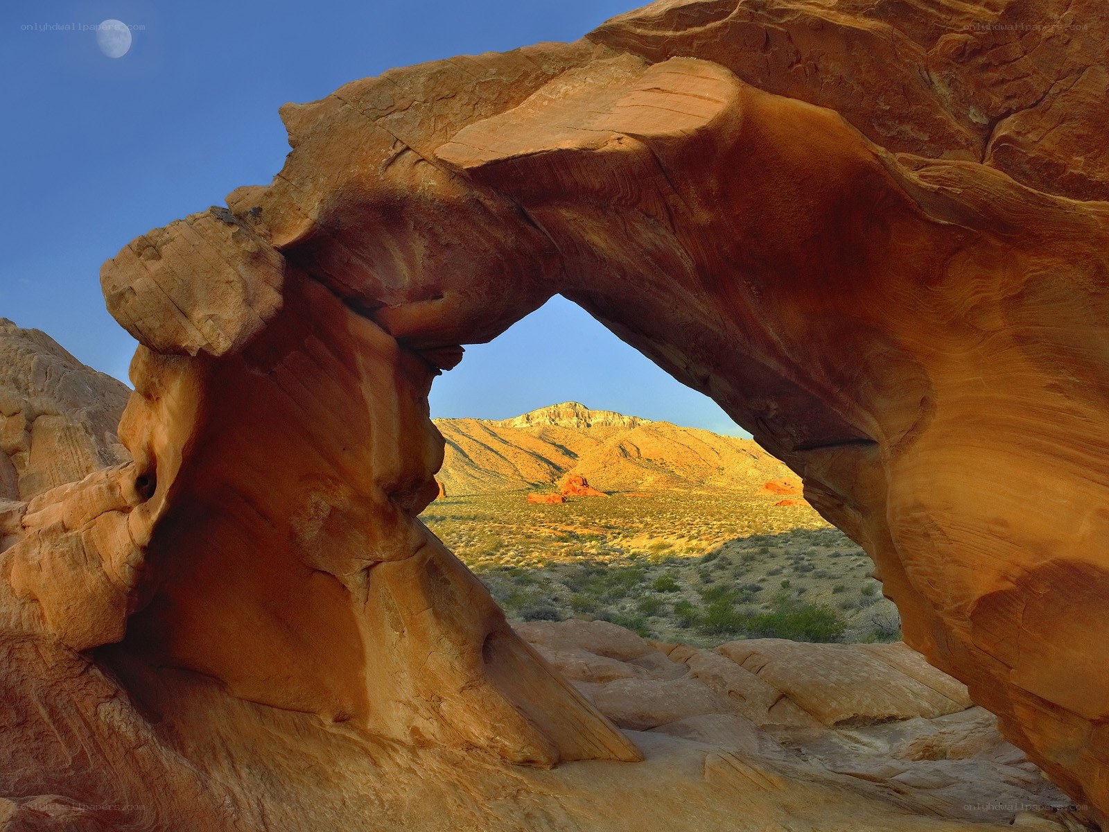 Natural rock arch with moon
