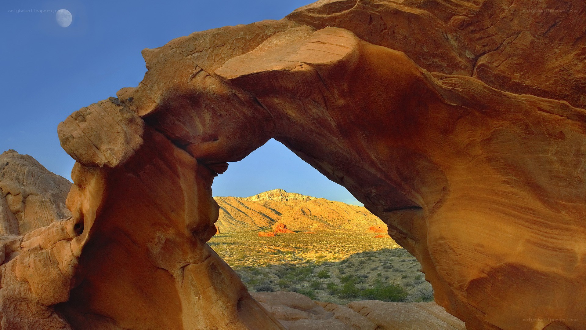 Natural rock arch with moon