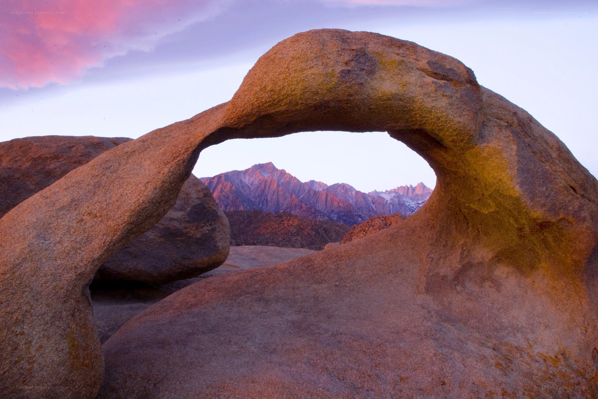 Natural rock arch with mountain view