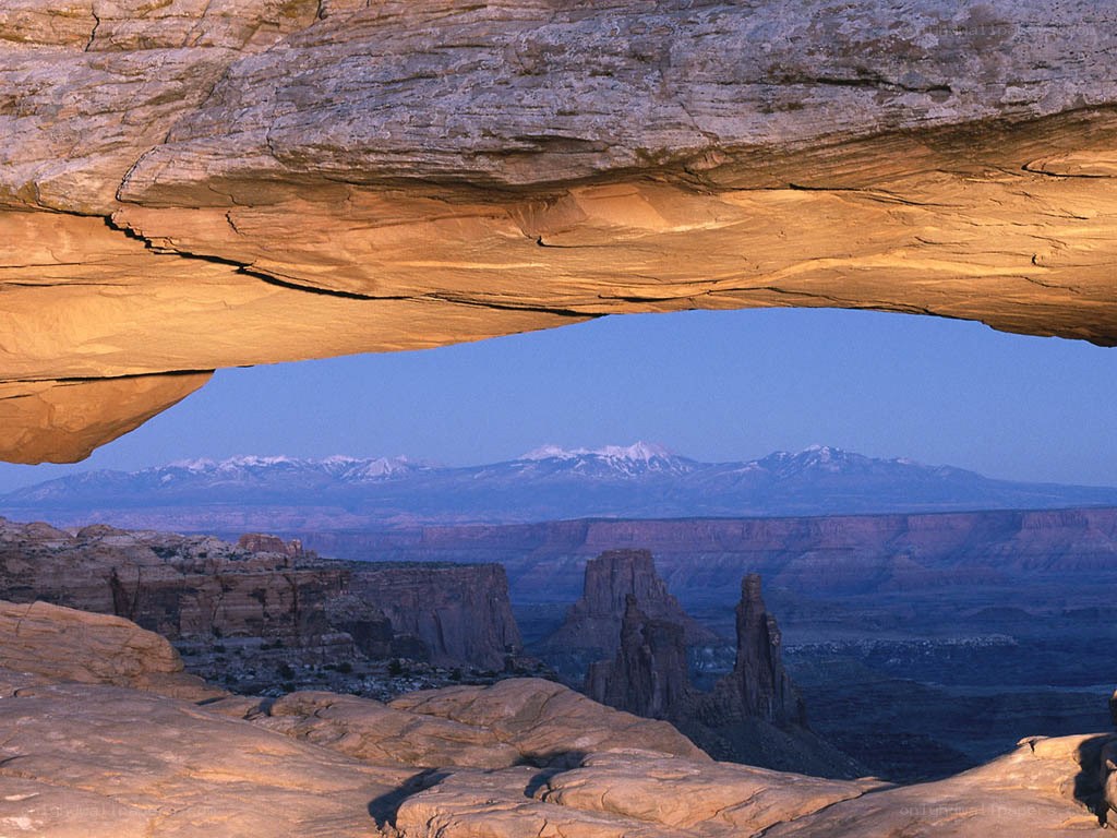Natural rock arch with mountain view